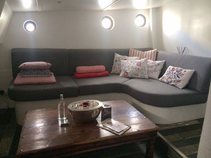 A re-upholstered yacht seating area with shaped foam cushions