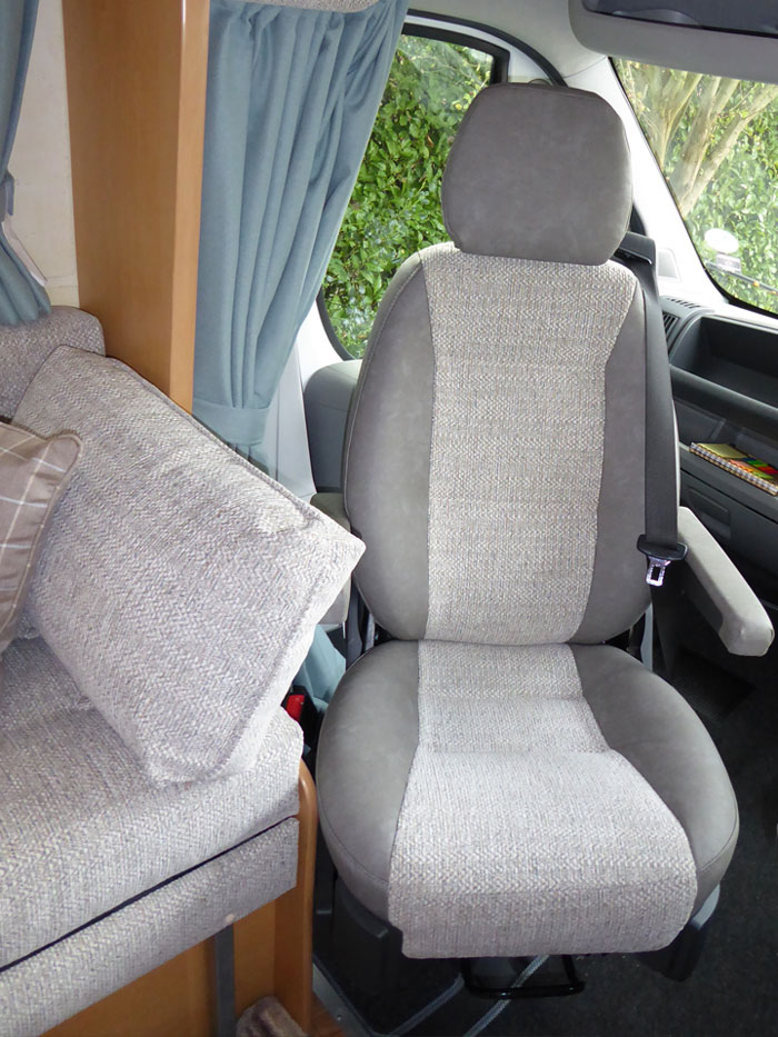 A motor home cab-seat and interior re-upholstered in matching fabrics