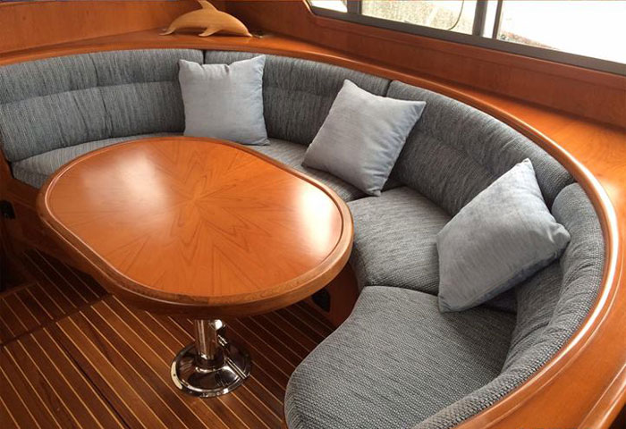 A shaped boat seating area re-upholstered in a contemporary fabric
